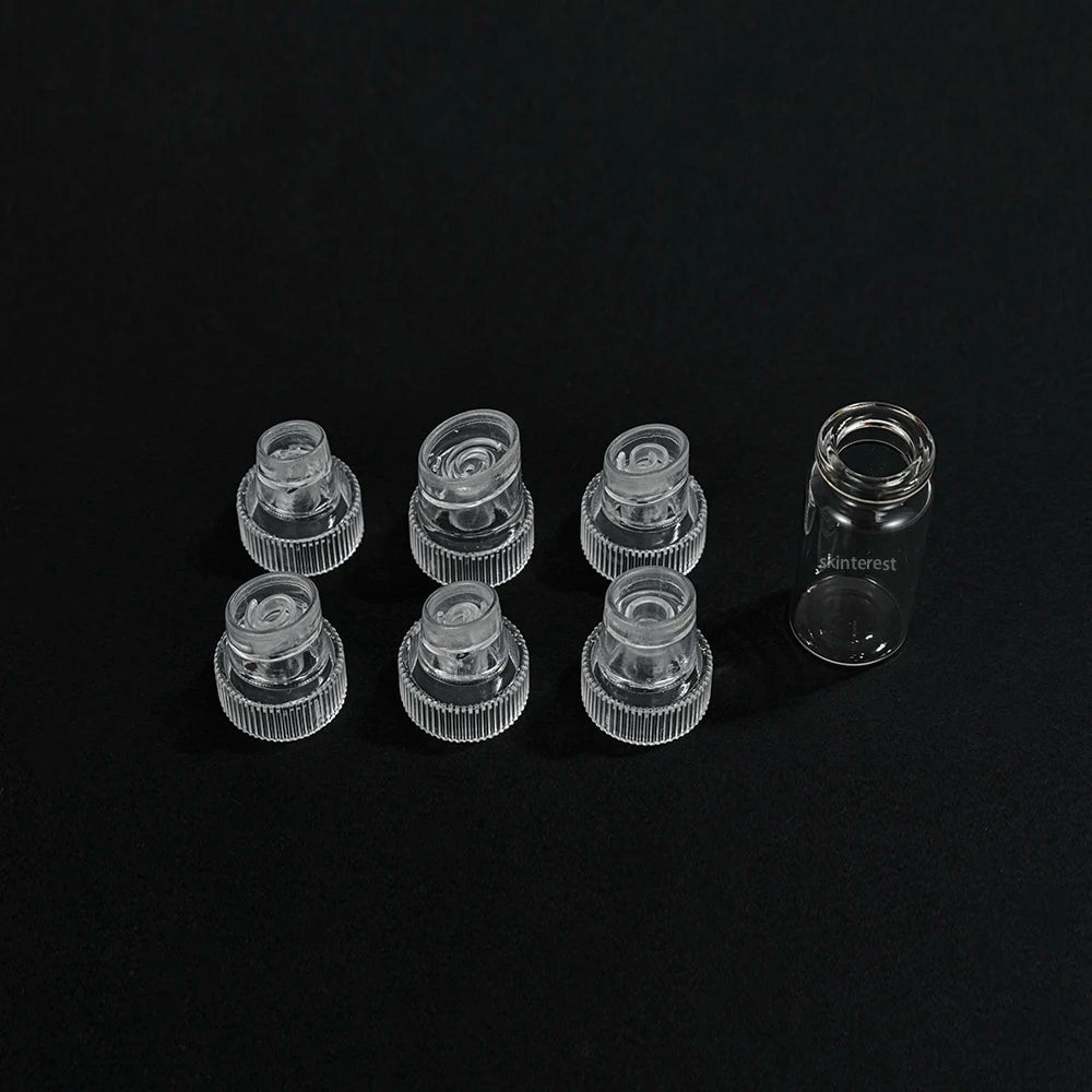 Set of clear plastic bottle caps on a black background