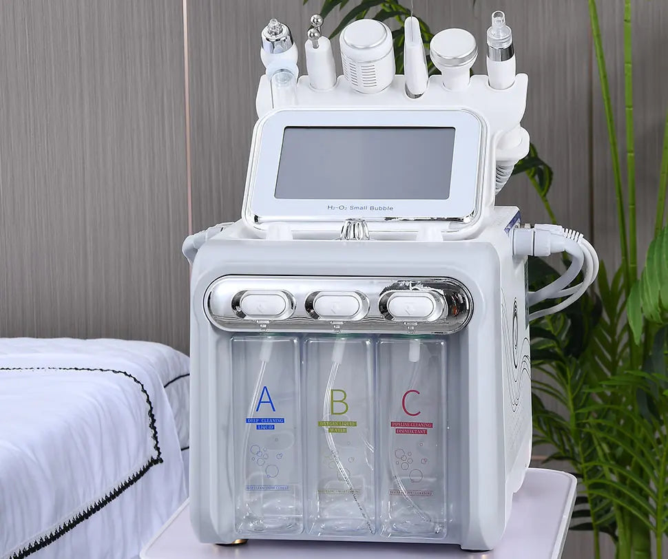 Beauty device with bottles labeled A, B, and C on a table with a plant in the background.